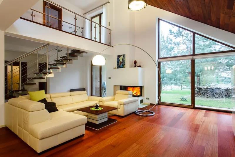 Finished living room with hardwood floors and open staircase